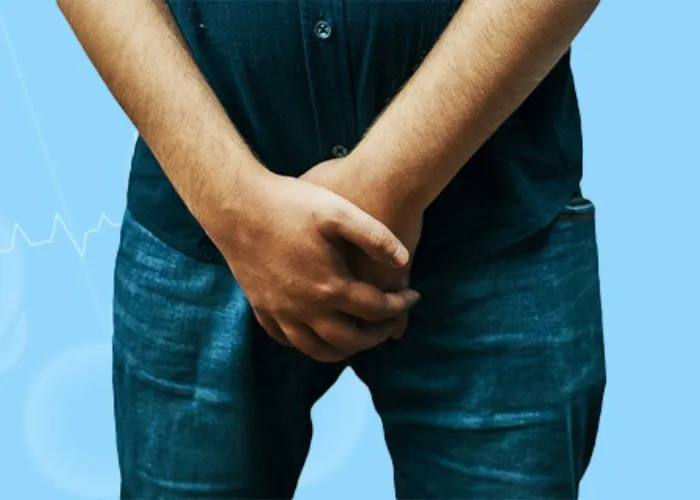 Man holding groin area indicating urinary discomfort or possible infection