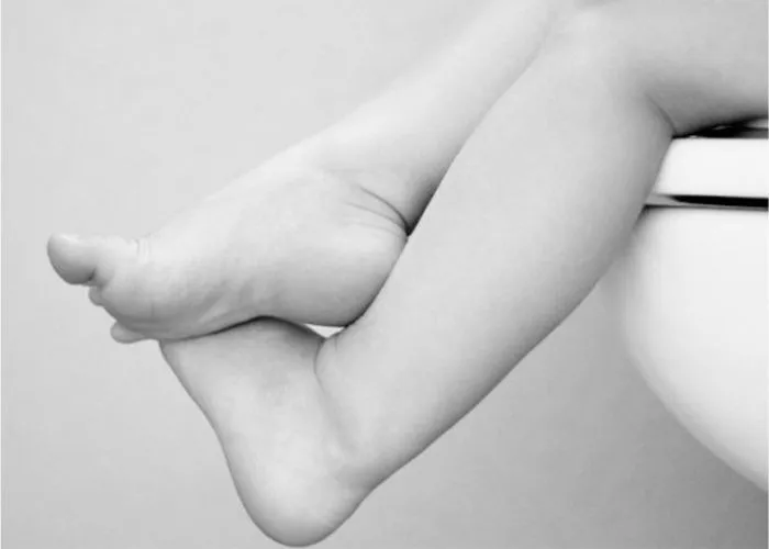 Child sitting on toilet representing pediatric urinary health and bladder control